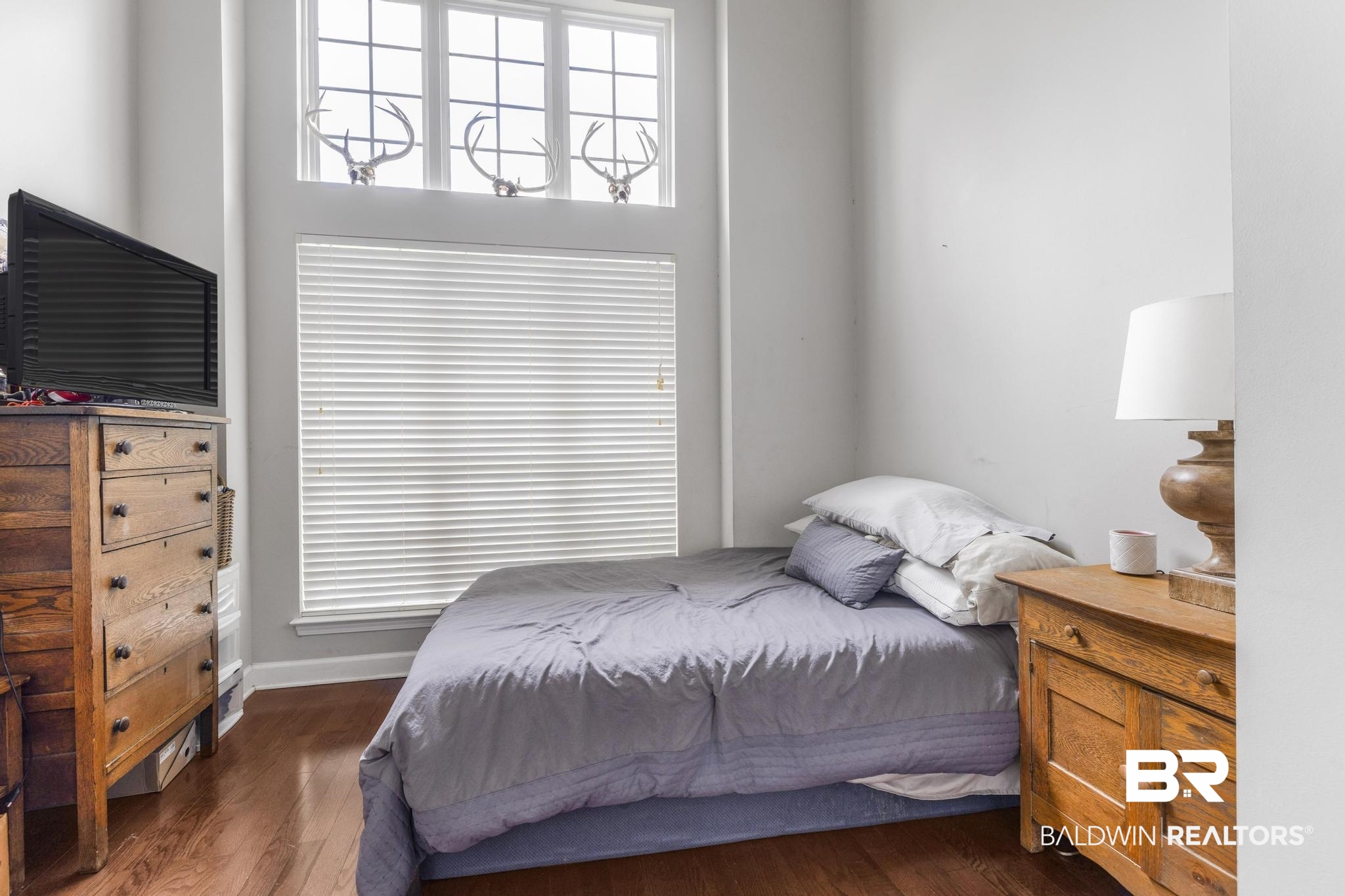 35814 Delvan Lane Bay Minette, AL 36507 - Photo 25 of 53 Hardwood-finish flooring complements the tall windows with transom architectural details