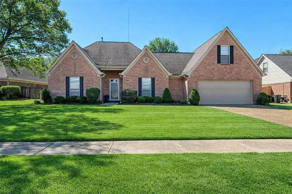 a front view of house with yard and green space