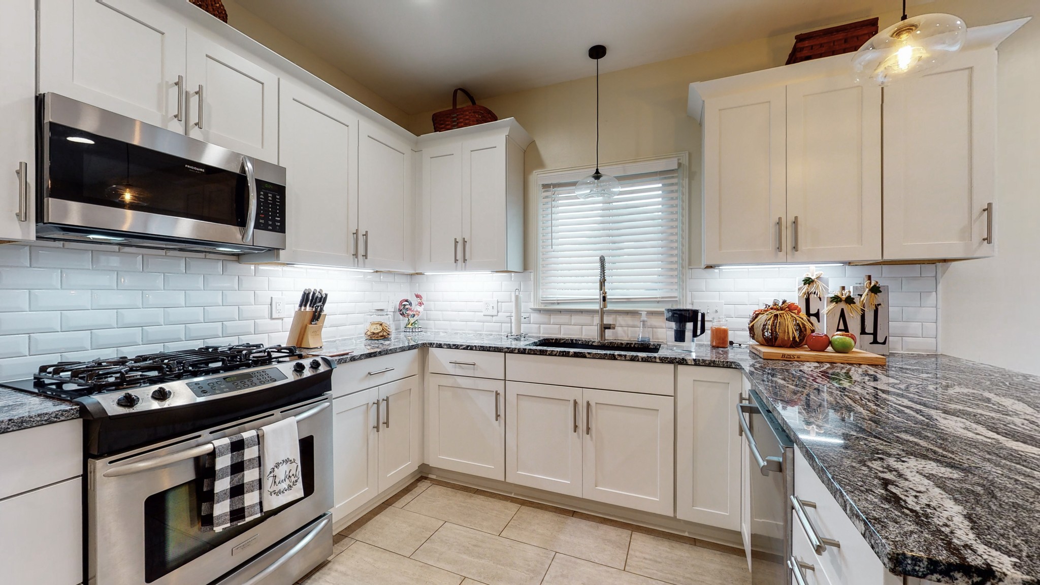 182 Scotsman Lane Franklin, TN 37064 - Photo 11 of 26 a kitchen with stainless steel appliances granite countertop white cabinets sink and stove