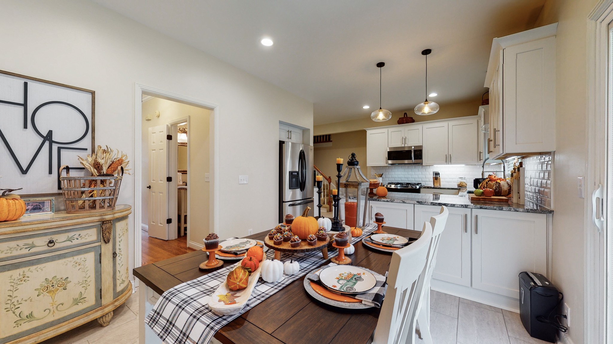 182 Scotsman Lane Franklin, TN 37064 - Photo 9 of 26 a kitchen with sink refrigerator stove dining table and chairs