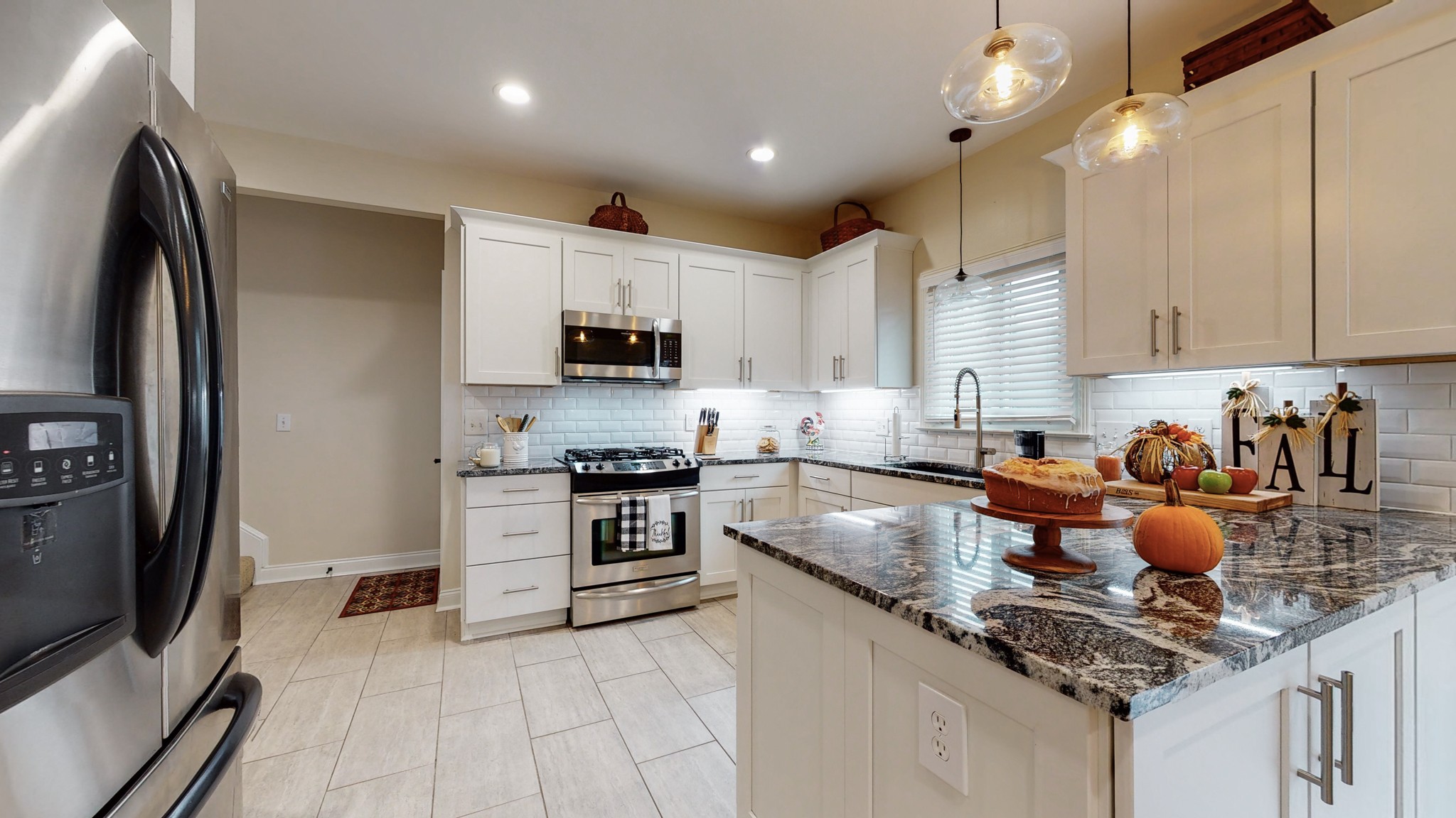 182 Scotsman Lane Franklin, TN 37064 - Photo 10 of 26 a kitchen with stainless steel appliances granite countertop a sink a stove and a refrigerator