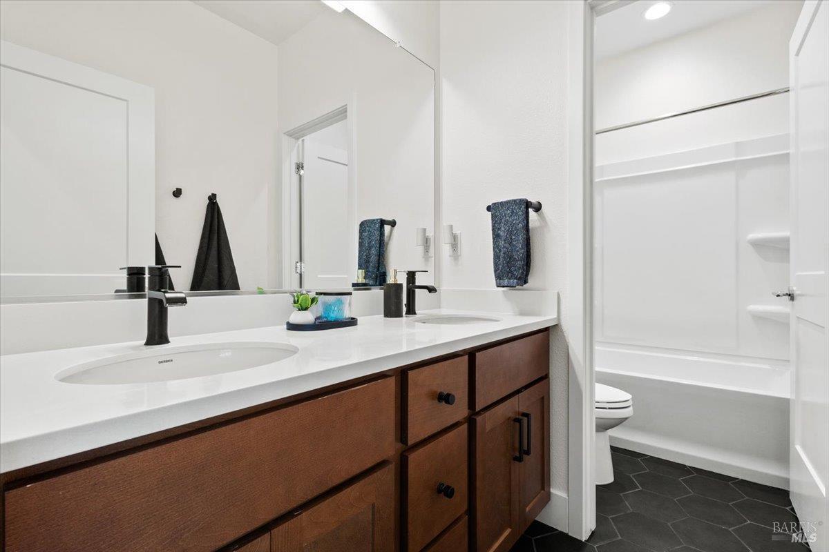 1469 Oak Circle Rohnert Park, CA 94928 - Photo 28 of 42 Upstairs Bathroom Designed for Busy Mornings A spacious dual-sink vanity is thoughtfully separated from the shower and toilet area, allowing multiple people to comfortably use the space at the same time.
