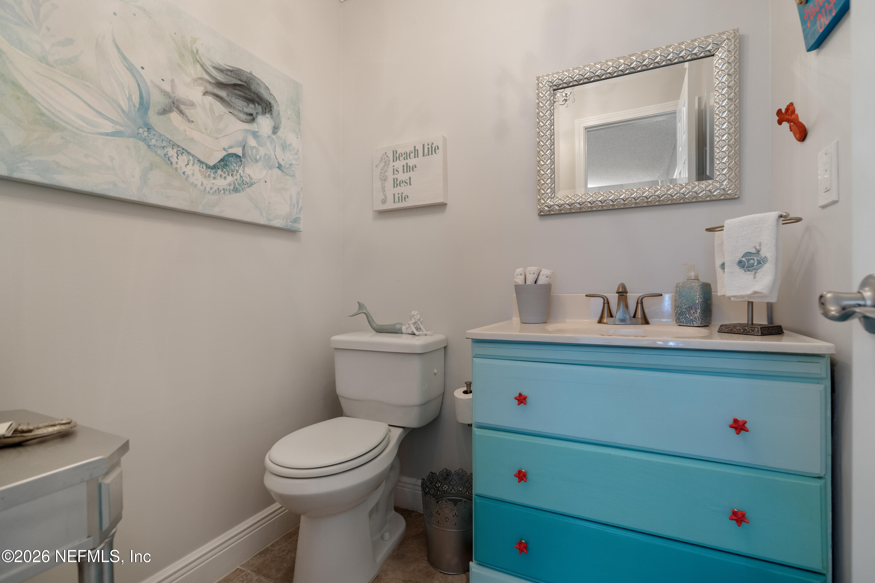 204 Gerado Street, Unit 3 St. Augustine, FL 32080 - Photo 14 of 31 a bathroom with a toilet sink vanity and mirror