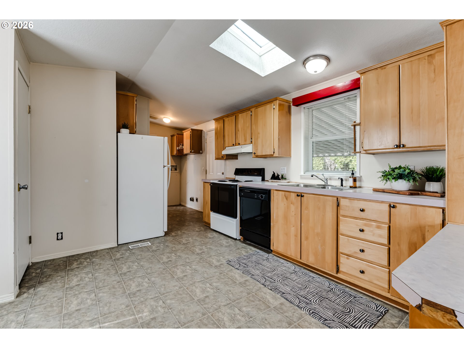 1699 North Terry Street Eugene, OR 97402 - Photo 4 of 30 a kitchen with granite countertop white cabinets and stainless steel appliances