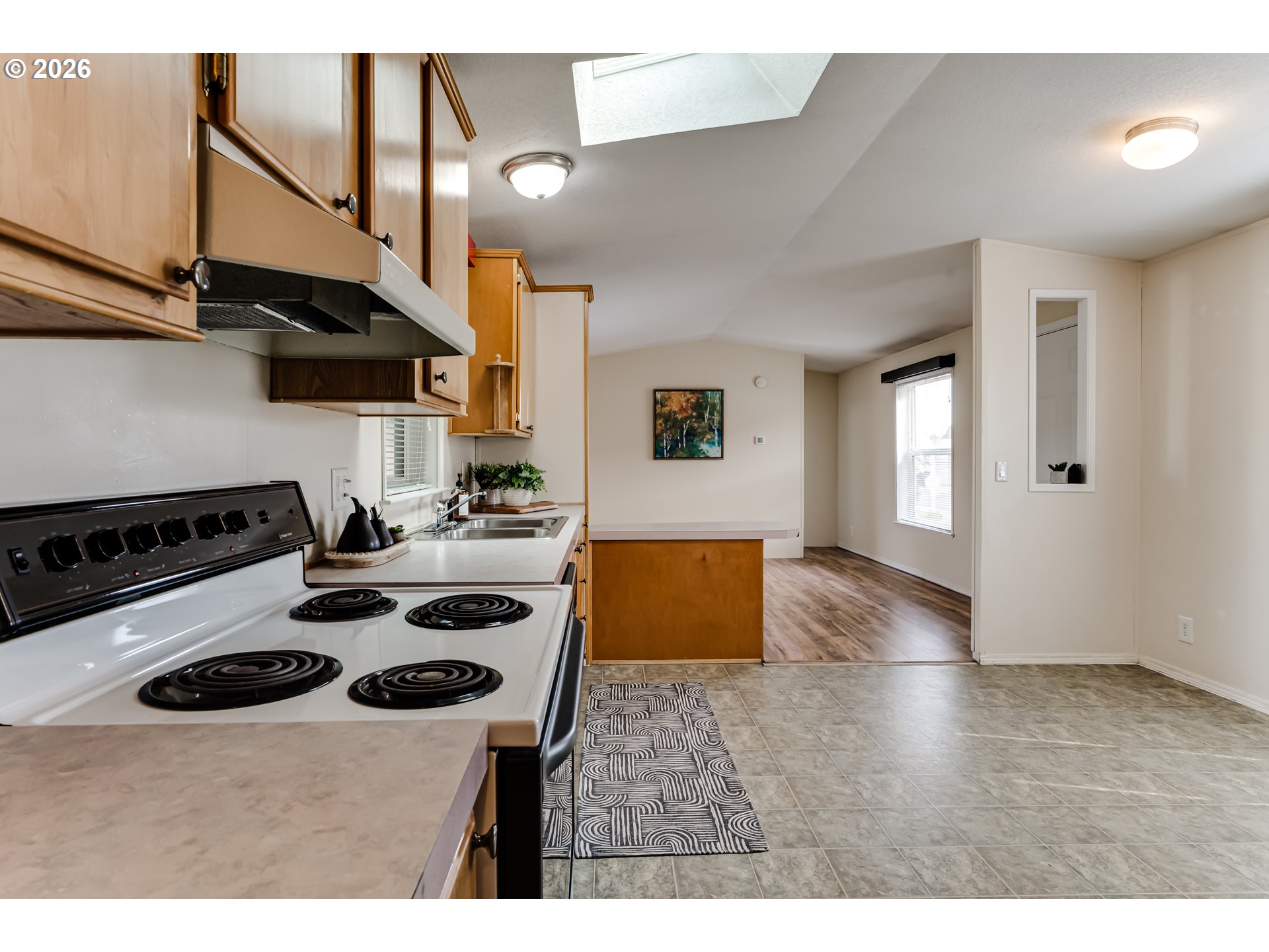 1699 North Terry Street Eugene, OR 97402 - Photo 8 of 30 a kitchen with a stove a sink and a refrigerator