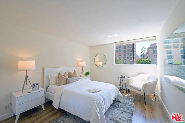 a bedroom with a bed chair and a window