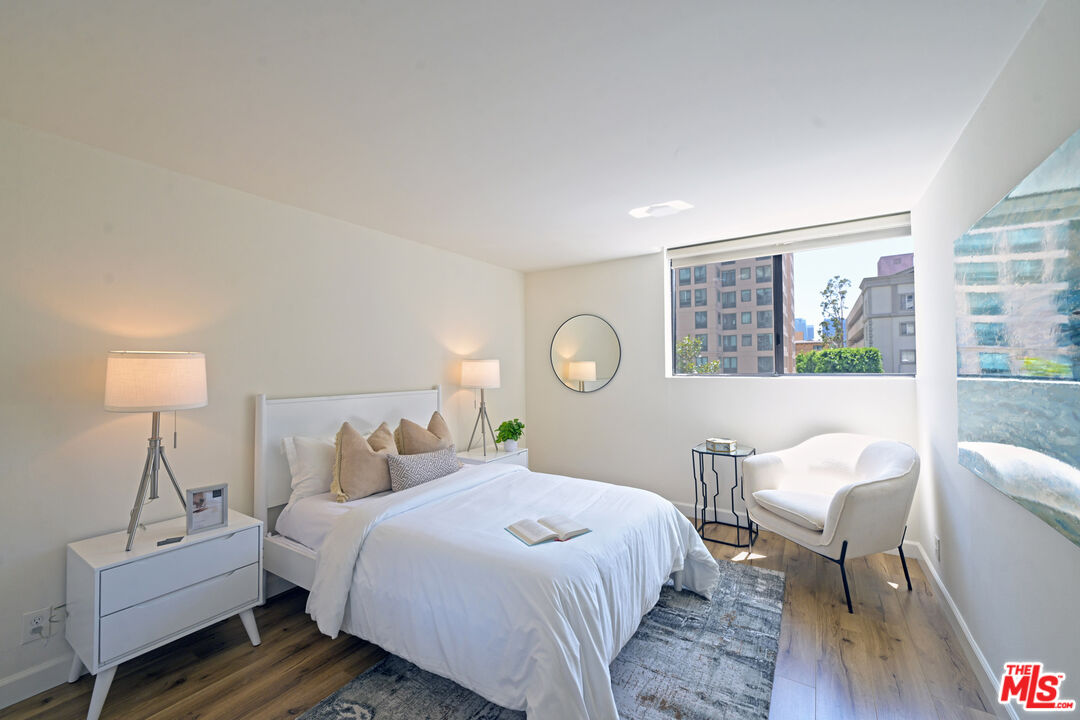 10535 Wilshire Boulevard, Unit 414 Los Angeles, CA 90024 - Photo 23 of 41 a bedroom with a bed chair and a window
