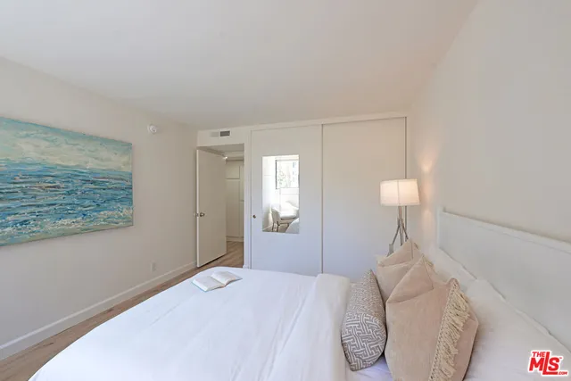 a bedroom with a bed and a lamp