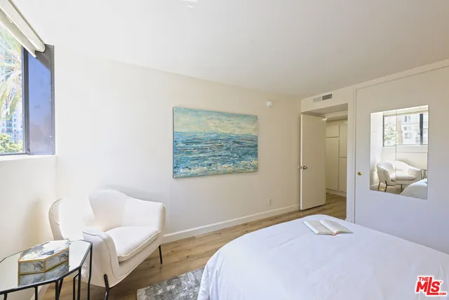 a bedroom with a bed and chair