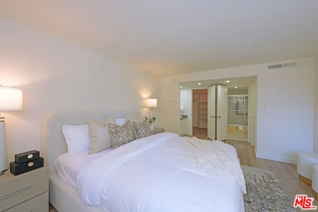 a bedroom with a bed and a lamp