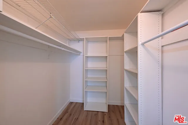 a view of walk in closet with empty racks
