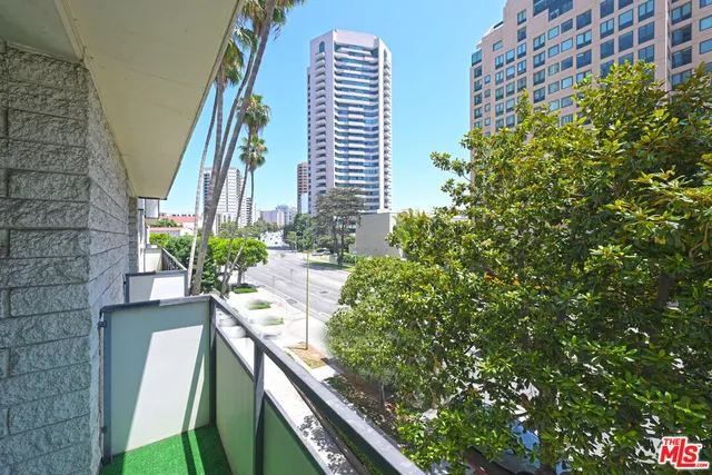 a view of balcony with wooden floor and plants