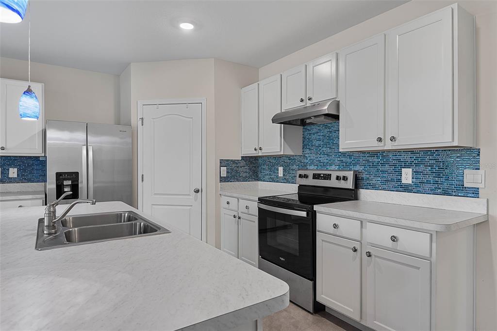247 Old Mill Edgewater, FL 32141 - Photo 16 of 67 a kitchen with cabinets appliances and a counter space