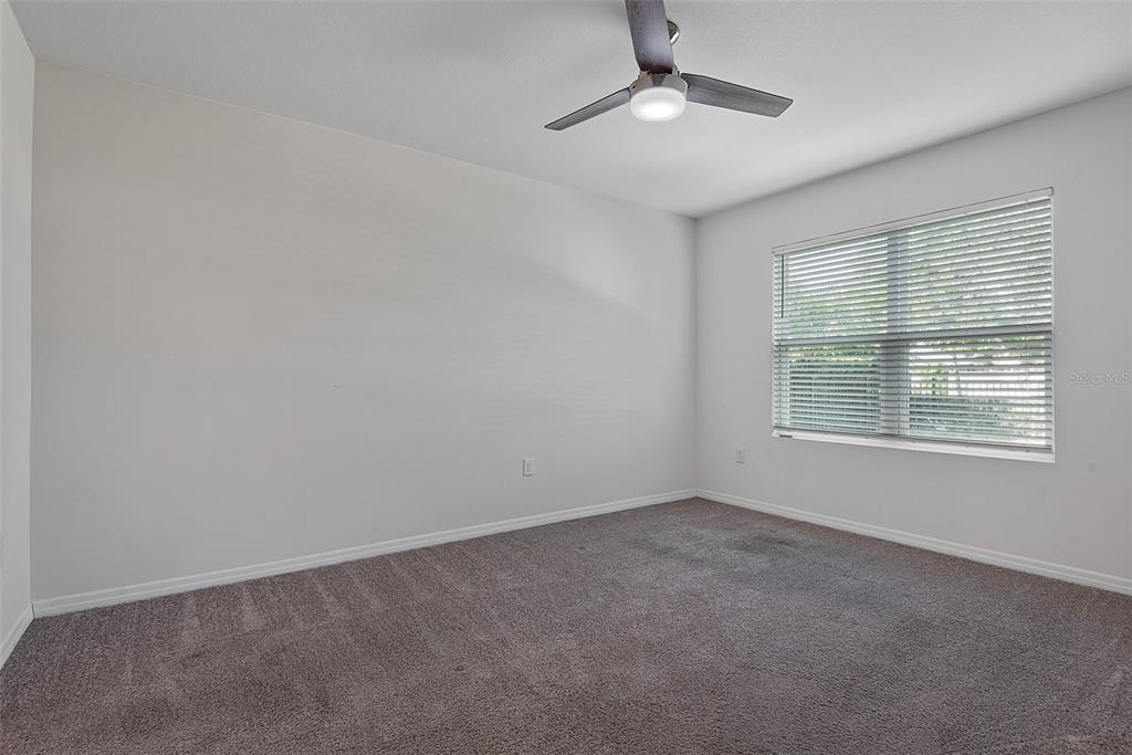 247 Old Mill Edgewater, FL 32141 - Photo 20 of 67 an empty room with a ceiling fan and windows