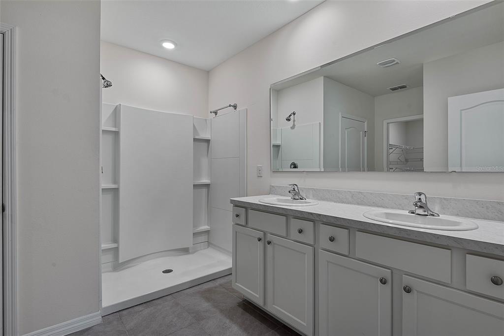 247 Old Mill Edgewater, FL 32141 - Photo 24 of 67 a bathroom with a shower sink vanity and mirror