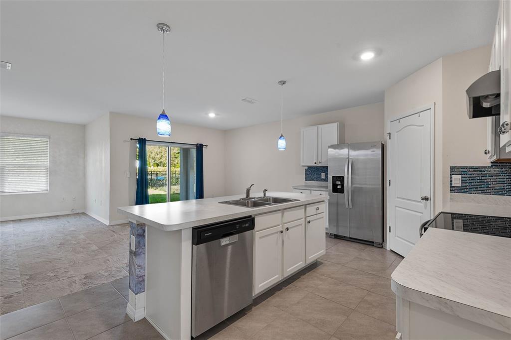 247 Old Mill Edgewater, FL 32141 - Photo 4 of 67 a kitchen with a sink stove and refrigerator