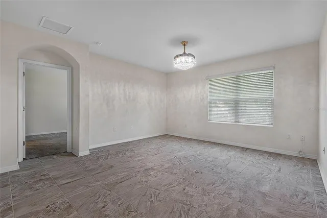 a kitchen with white cabinets and refrigerator