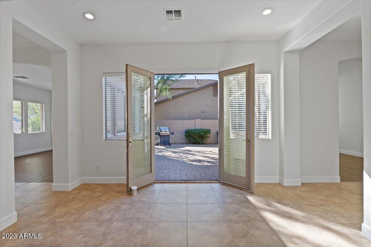 2413 West Sienna Bouquet Place Phoenix, AZ 85085 - Photo 14 of 61 a view of a hallway with wooden floor and a living room