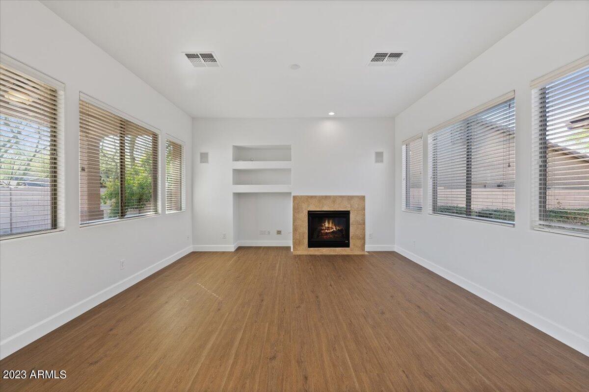 2413 West Sienna Bouquet Place Phoenix, AZ 85085 - Photo 16 of 61 a view of an empty room with a window and wooden floor
