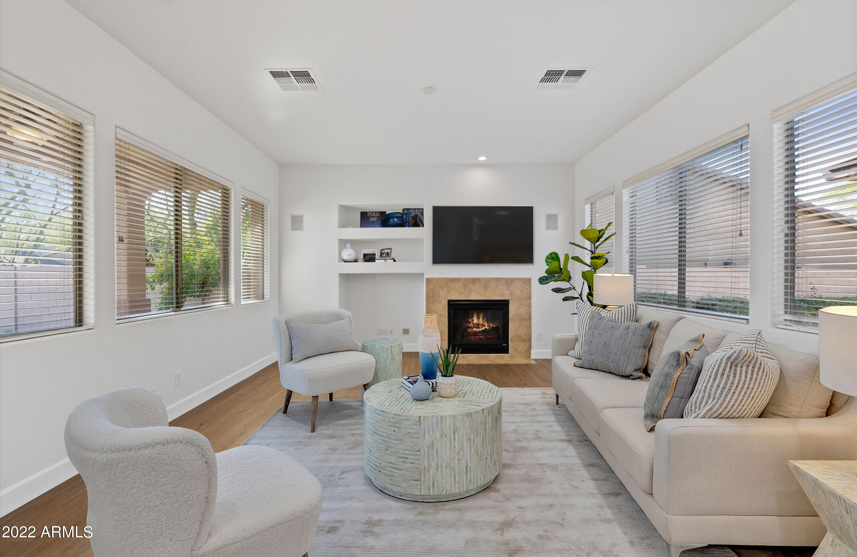 2413 West Sienna Bouquet Place Phoenix, AZ 85085 - Photo 17 of 61 a living room with furniture a flat screen tv and a fireplace