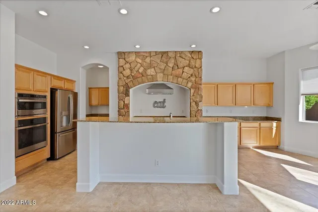 a view of a kitchen with marble wall