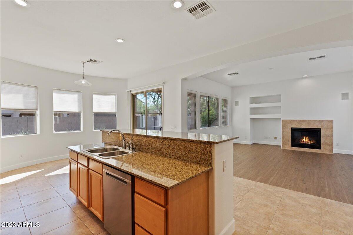 2413 West Sienna Bouquet Place Phoenix, AZ 85085 - Photo 22 of 61 a living room with stainless steel appliances granite countertop a sink a stove and a wooden floors