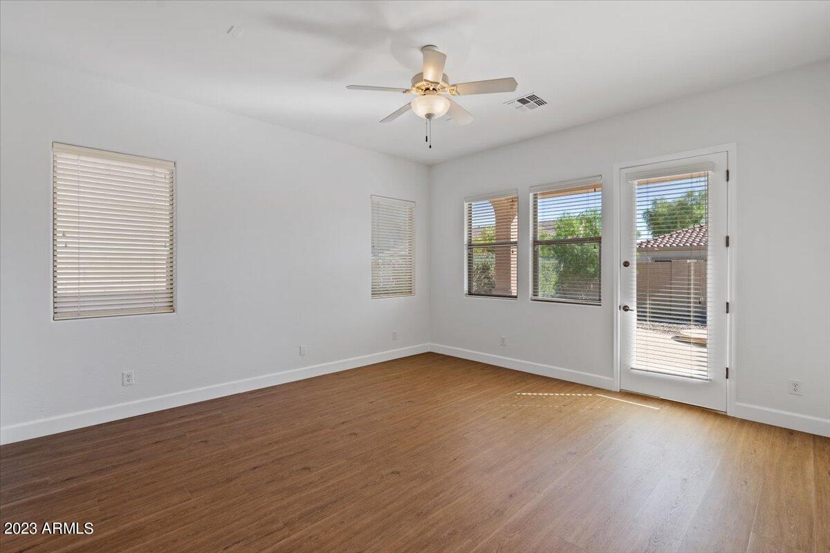 2413 West Sienna Bouquet Place Phoenix, AZ 85085 - Photo 26 of 61 a view of an empty room with wooden floor and a window