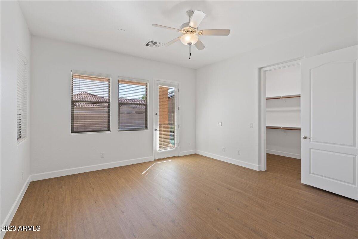 2413 West Sienna Bouquet Place Phoenix, AZ 85085 - Photo 29 of 61 a view of an empty room with a window and wooden floor