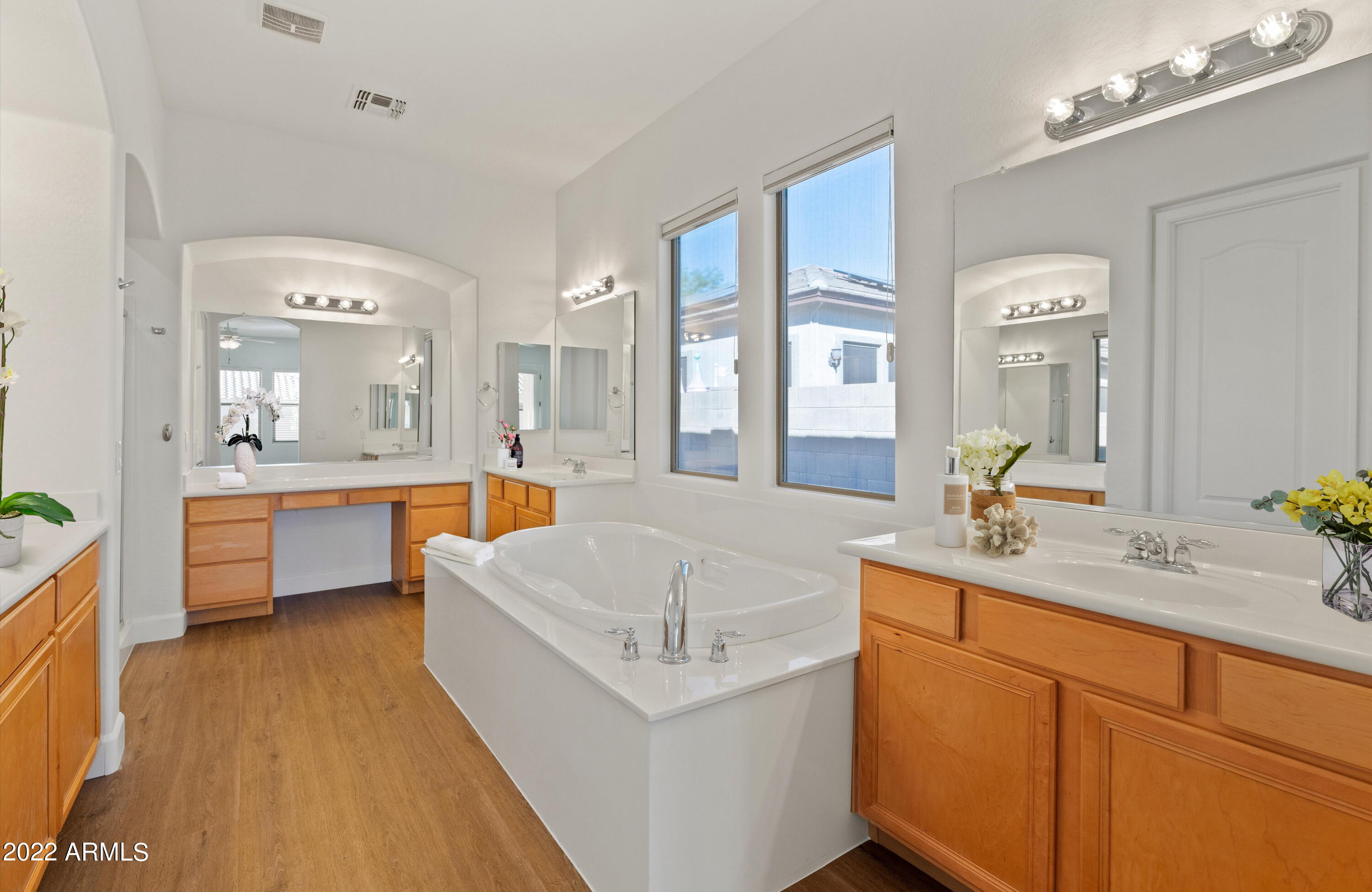 2413 West Sienna Bouquet Place Phoenix, AZ 85085 - Photo 31 of 61 a en suite bathroom with a double vanity sink a mirror a bathtub and a shower