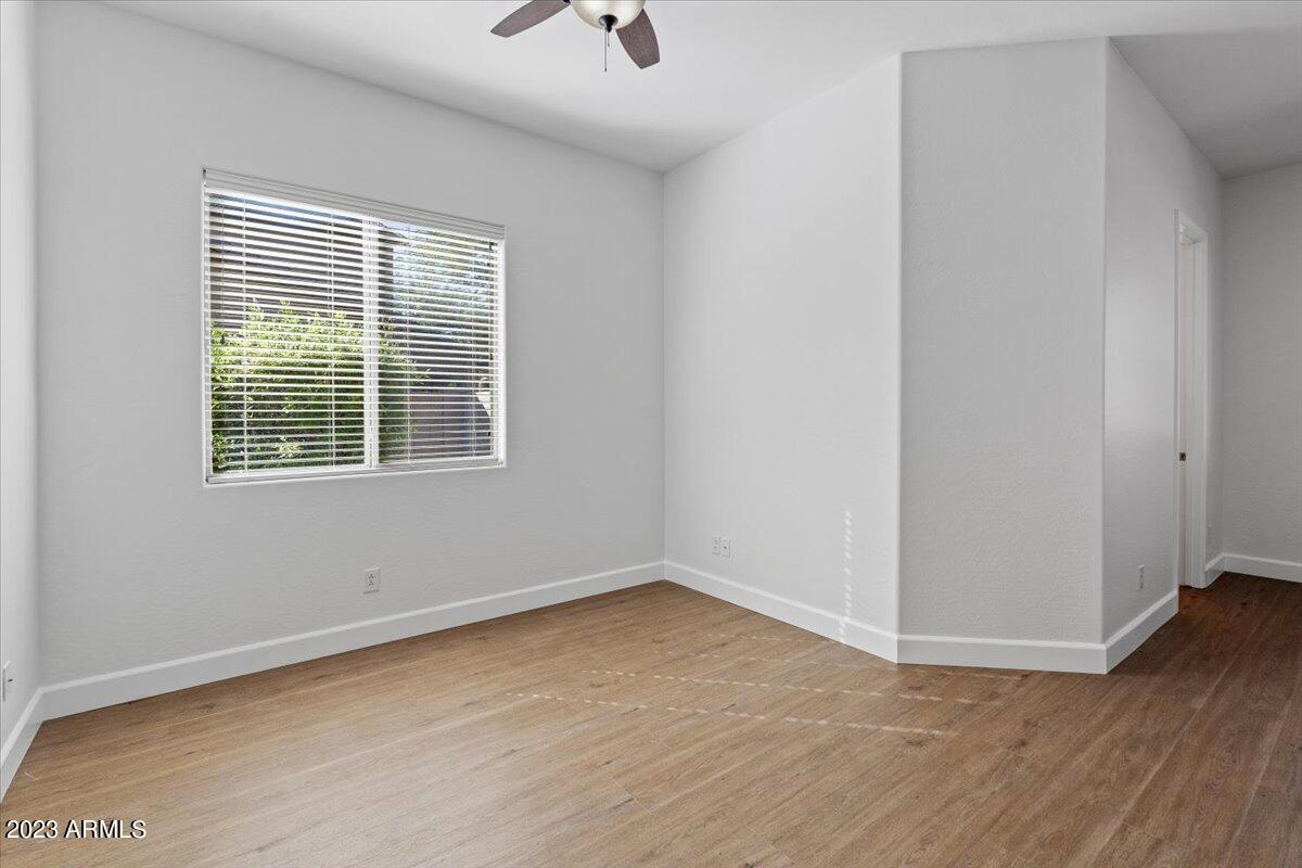 2413 West Sienna Bouquet Place Phoenix, AZ 85085 - Photo 34 of 61 an empty room with wooden floor and windows