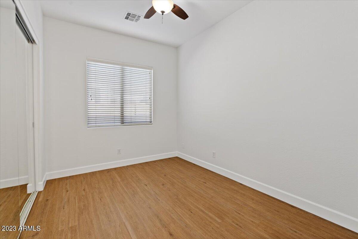 2413 West Sienna Bouquet Place Phoenix, AZ 85085 - Photo 42 of 61 an empty room with a window and wooden floor