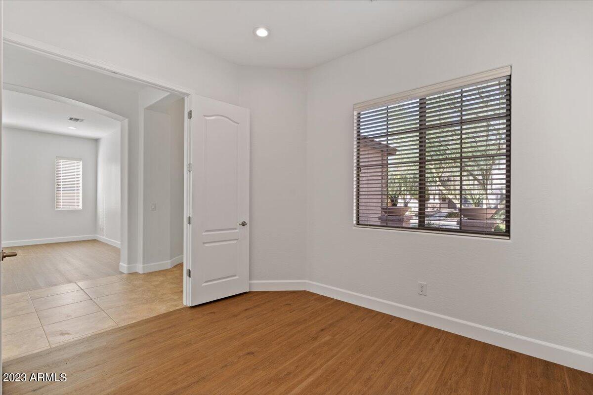 2413 West Sienna Bouquet Place Phoenix, AZ 85085 - Photo 45 of 61 a view of an empty room with wooden floor and a window