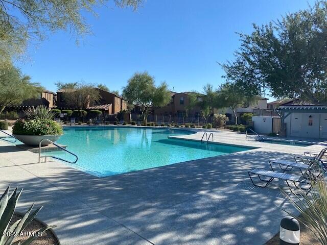 2413 West Sienna Bouquet Place Phoenix, AZ 85085 - Photo 51 of 61 a view of a swimming pool with a patio and a yard