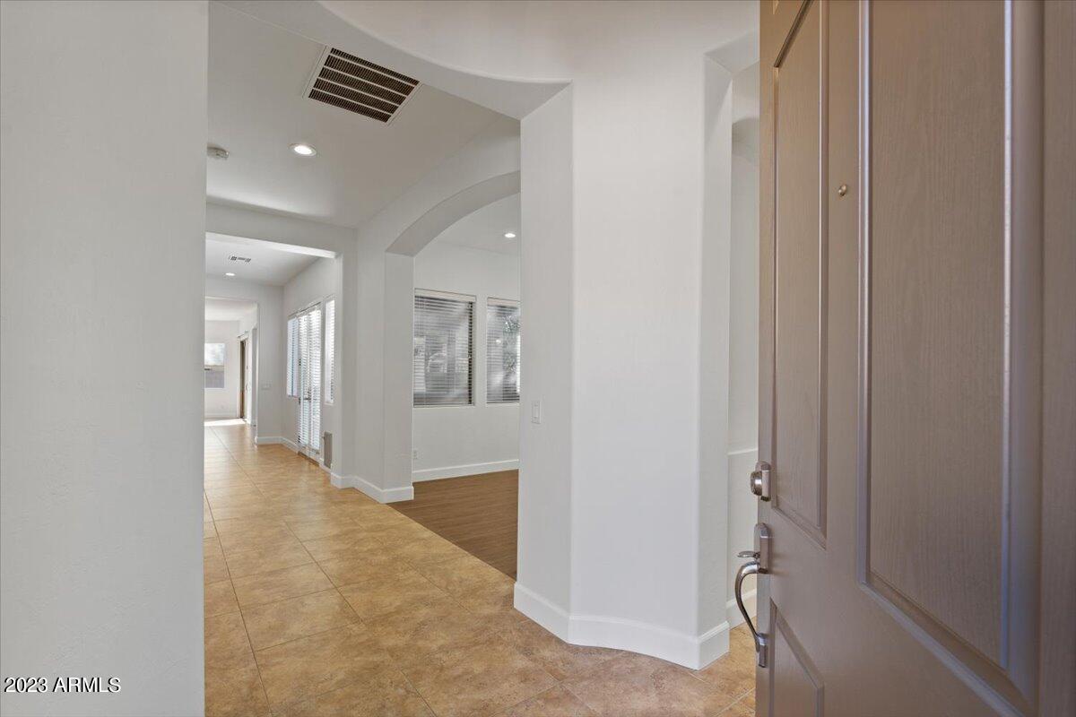 2413 West Sienna Bouquet Place Phoenix, AZ 85085 - Photo 8 of 61 a view of a hallway with wooden floor and a bathroom