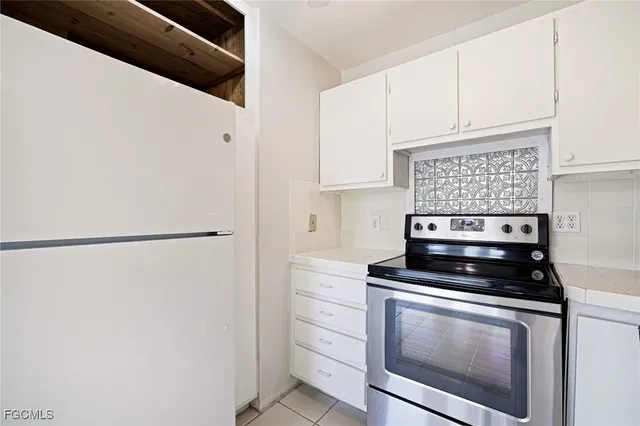 a kitchen with appliances a sink and cabinets