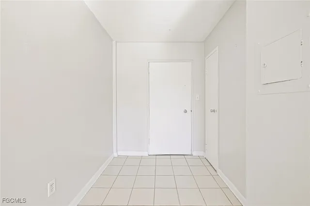 a view of a kitchen with wooden cabinet and a refrigerator