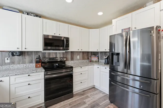 a kitchen with cabinets stainless steel appliances and a counter space