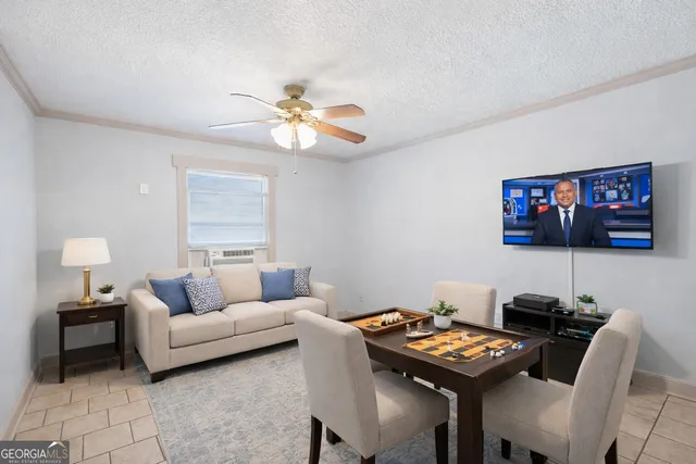 a living room with furniture a rug and a flat screen tv