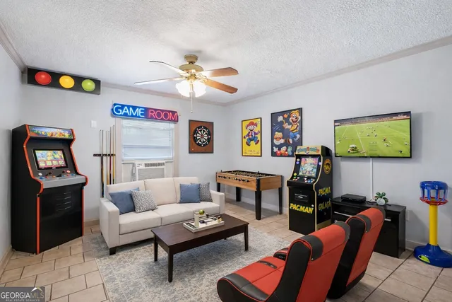 a living room with furniture a flat screen tv and a wall paintings