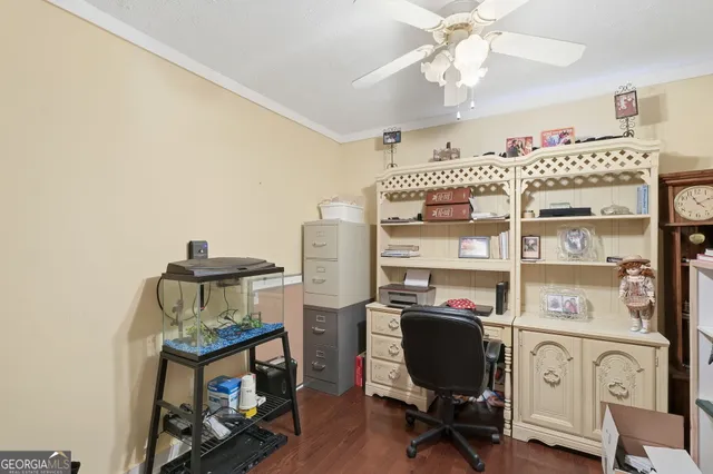 a view of a workspace with furniture and a window