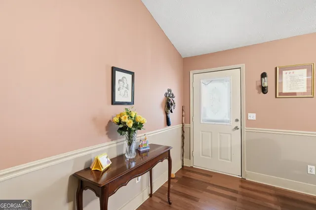 a dining room with furniture and wooden floor