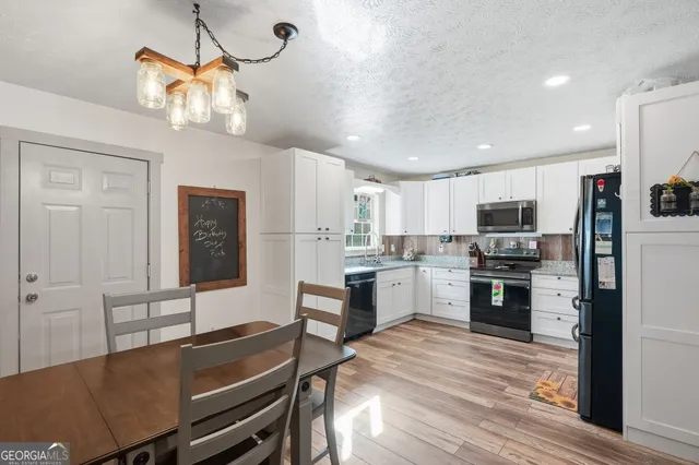 a kitchen with stainless steel appliances kitchen island granite countertop a stove and refrigerator