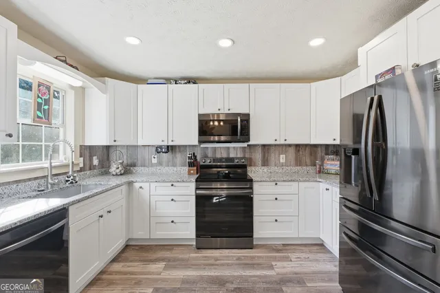 a kitchen with a refrigerator stove and sink