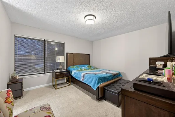 a bedroom with a bed and large window
