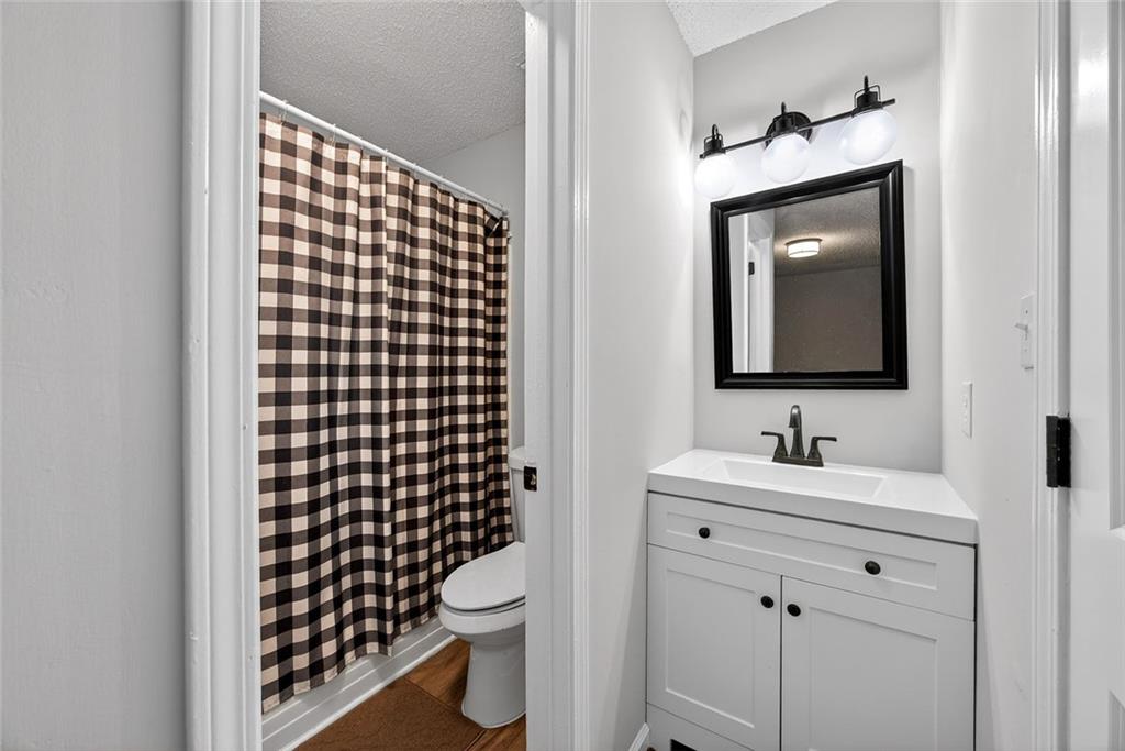 2739 Whitewater Court Austell, GA 30106 - Photo 14 of 18 a bathroom with a toilet sink vanity and mirror