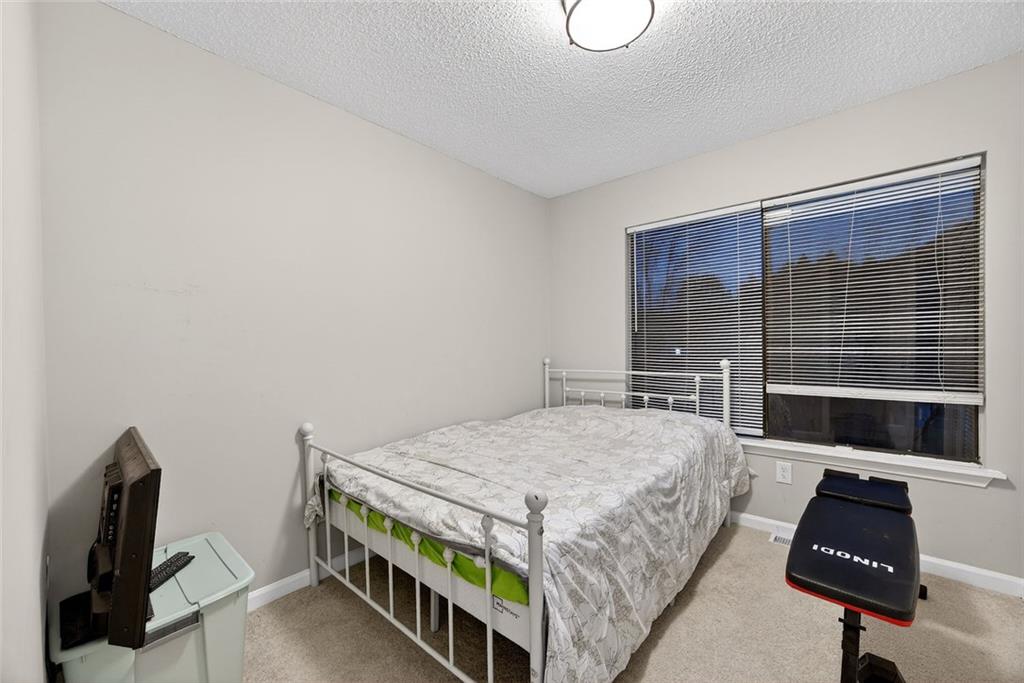 2739 Whitewater Court Austell, GA 30106 - Photo 15 of 18 a bedroom with a bed and a flat screen tv