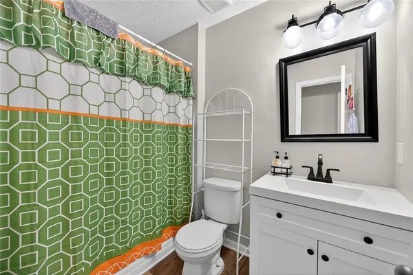 a bathroom with a toilet sink and mirror