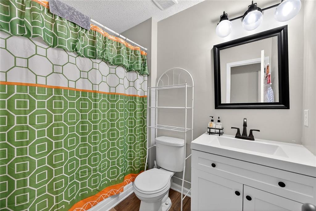 2739 Whitewater Court Austell, GA 30106 - Photo 16 of 18 a bathroom with a toilet sink and mirror