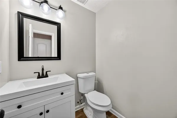 a bathroom with a toilet a sink and mirror