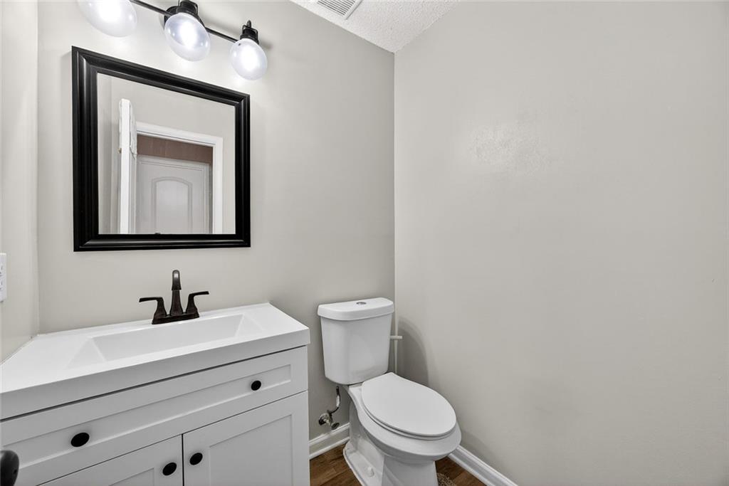 2739 Whitewater Court Austell, GA 30106 - Photo 7 of 18 a bathroom with a toilet a sink and mirror